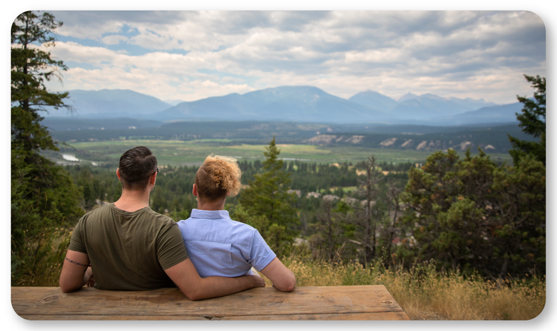 couple sitting at picnic bench overlooking valley